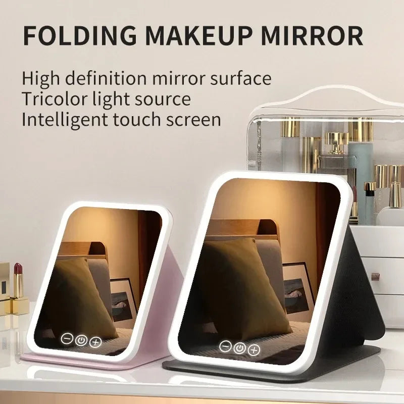 The Spotlight LED travel makeup mirror in pink and black, both open and lit
